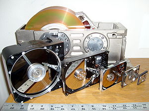 Six hard disk drives with cases opened showing...